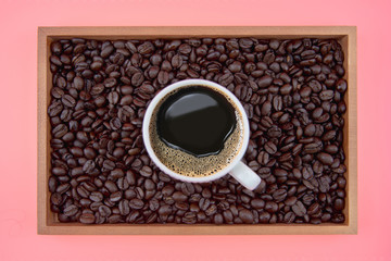 Coffee cup and coffee beans in box