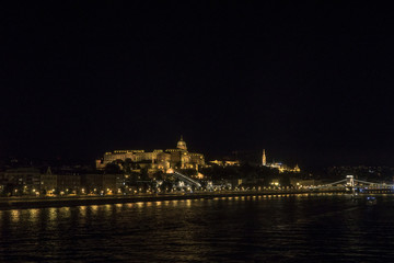 Obraz na płótnie Canvas Night Budapest at the river Danube. Buda Castle (Royal Palace) and Chain bridge (Szechenyi lanchid) on background. Hungary