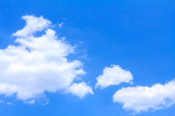 Blue sky background with white clouds on sunny summer or spring day.