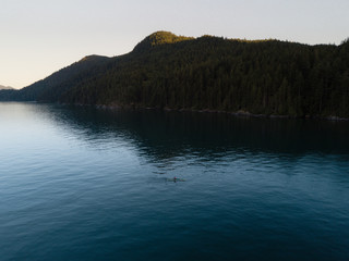 Aerial shot of kayak on lake and sunset