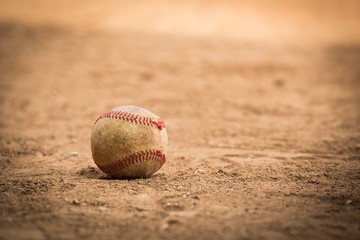 baseball sitting on dirt