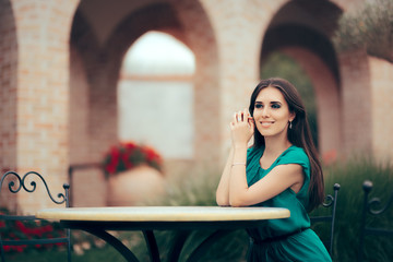 Smiling Woman Waiting for an Important Date at a Restaurant Table