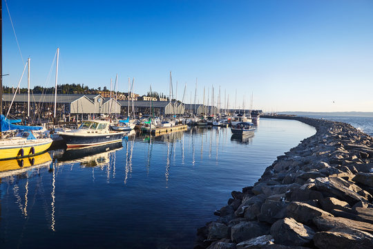 Marina And Covered Boat Slips In Edmonds, Washington On A Sunny Summer Evening