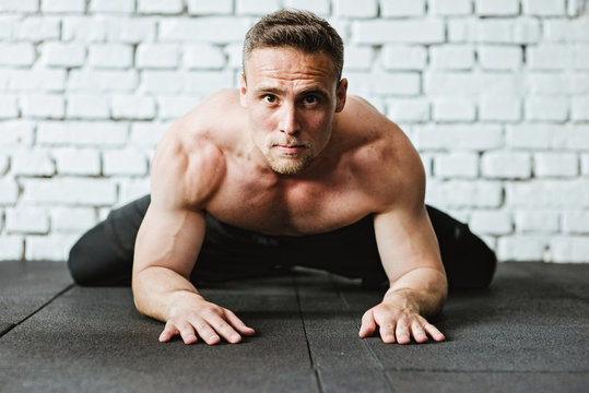 Man doing stretching exercises at gym