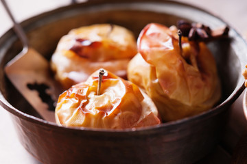 Fruit dessert baked apple in a pan and metal paddle 