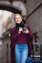 Girl taking picture with camera in the town