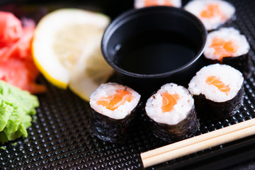 Sushi rolls with salmon, soy sauce and chopsticks 