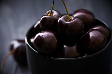 Cherries in black bowl - 164919976