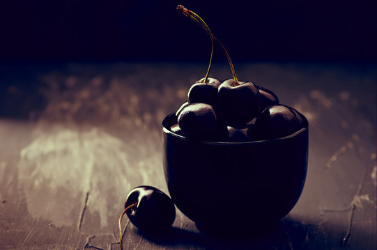 Cherries In Black Bowl