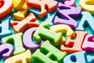 Multiple colored letters on wooden table