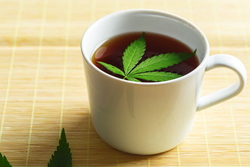 Cannabis herbal tea and marijuana leaves