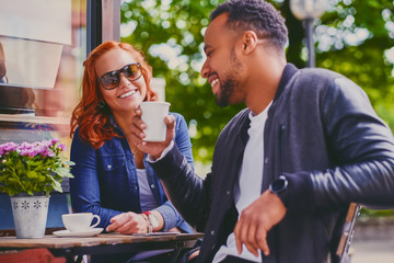Couple drinks coffee in a cafe.