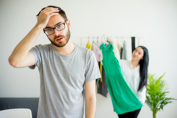 Bored husband waiting for wife