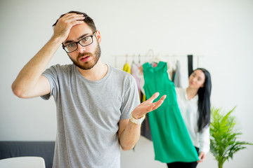 Bored husband waiting for wife