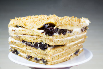 Creamy cake on plate on table