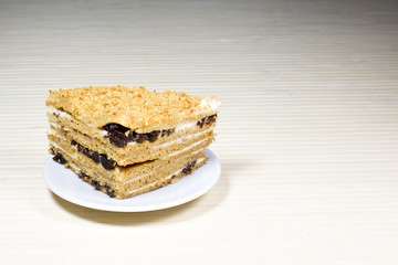 Creamy cake on plate on table