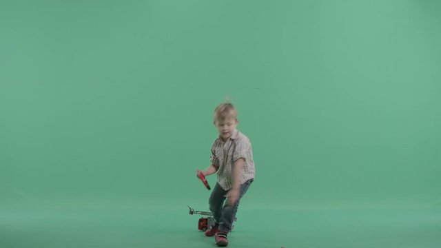 Cute enthusiastic kid plays with his remote controlled car