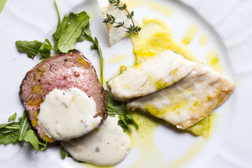beef meat and fish in a plate