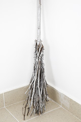 Old broom isolated on white. Witch's broomstick.