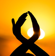 Silhouette of a girl's hand on a beautiful sunset