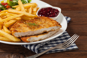 Chicken schnitzel, served with fries and salad.