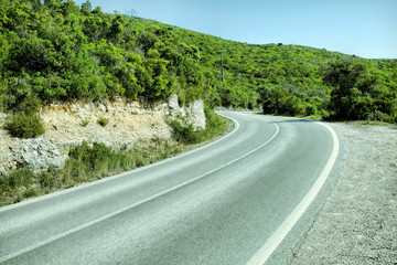 Empty two lane asphalt road highway vanishing in perspective