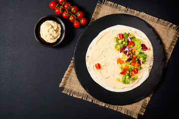 Tortilla with vegetables and hummus with chickpeas