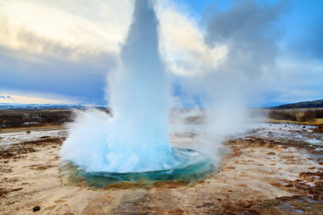 Fototapeta premium The Strokkur Geyser erupting at the Haukadalur geothermal area, part of the golden circle route, in Iceland