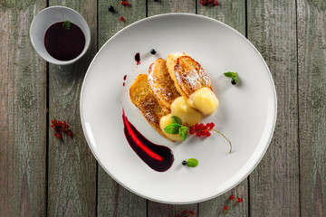 Plate of toasts with fruit jam and custard for healthy breakfast. Delicious European meal. Top view.