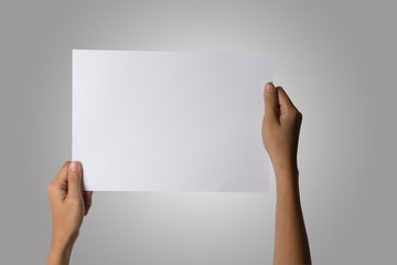 Fototapeta premium Close Up of woman hand holding blank paper isolated on white background