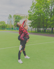 two beautiful girls on the school Playground, grimace.