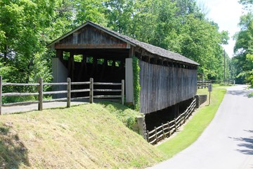 A front side view of the old covered bridge in the park.