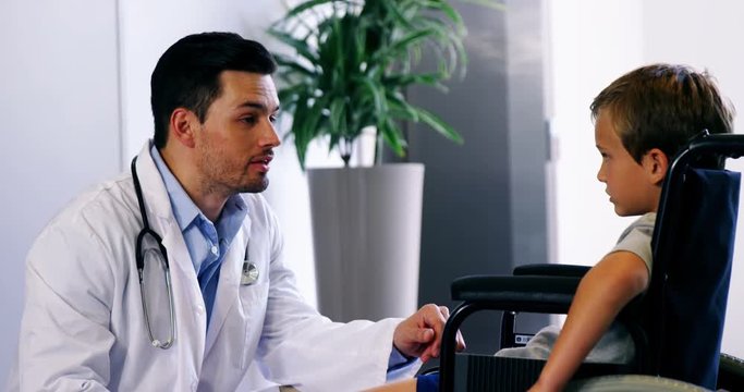 Doctor talking to disable boy