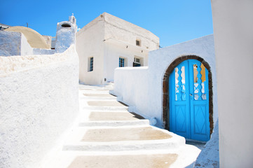 Traditional greek architecture with blue doors in the city of Pyrgos on the island of Santorini,...