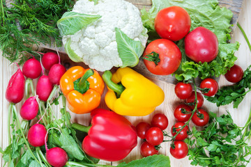 Different vegetables as a tomatoes, cauliflower, peppers, radishes, cherry tomatoes