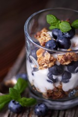 Glass with granola muesli, joghurt and blueberries