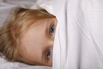 Adorable little girl sleeping in the bed