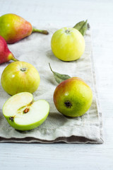 Fototapeta na wymiar Apples green on cotton napkin on white background.