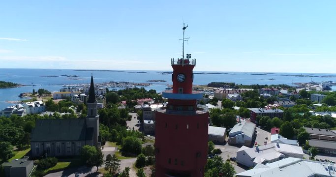 Watertower, Cinema 4k aerial sideway view of the city, from behind Hanko water tower, revealing the city, on Hango regatta day, in Uusimaa, Finland
