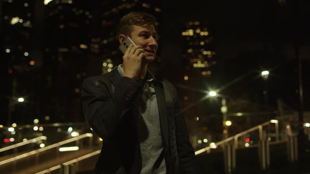 Young attractive man is talking over his smartphone and taking a selfie