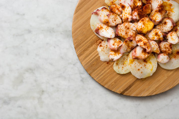 Pulpo a la gallega. Galician octopus on white marble. Typical spanish food
