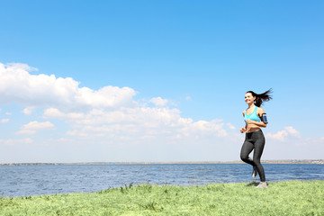 Attractive fitness woman running outdoors