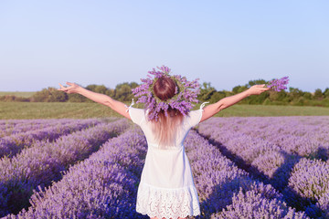 Young beautiful girl in lavender field