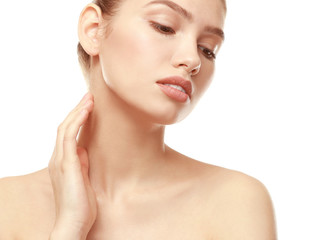 Closeup view of beautiful young woman with natural lips makeup touching neck on white background