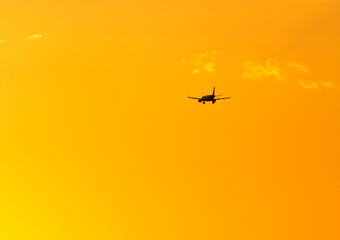 The plane is landing at sunset