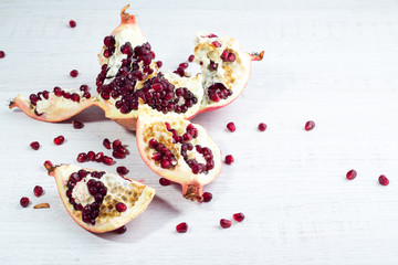 Garnet and pomegranate seeds on a white background.