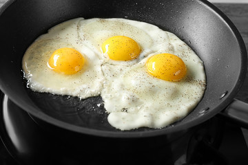 Delicious over easy eggs in pan, closeup
