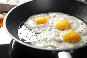 Delicious over easy eggs in pan, closeup