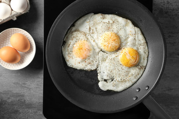 Delicious over easy eggs in pan on stove