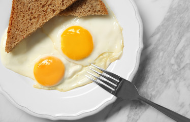 Delicious breakfast with over easy eggs on table